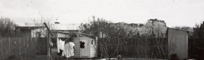 Photo from Museum Victoria. A typical backyard for the 50s and 60s, a fowl house, outside lavatory and a clothes line. 