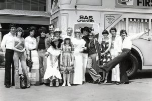 Local and interstate personalities from Channel 10, including stars from Number 96 in front of the Channel 10 promotion bus, preparing for the Christmas Appeal weekend. How many stars can you name?